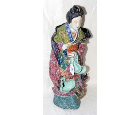 A 44cm high ceramic Chinese maiden with vibrant painted glaze and impress mark to the base