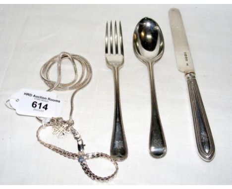 A silver knife, fork and spoon set, necklaces