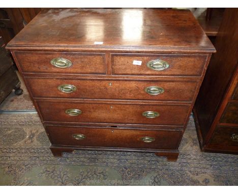An early 19th c. Oak Chest of three long and two short Drawers, having oval backplate brass drop handles and standing on brac