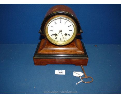 A Mantle clock, barrel shaped with gold coloured case, Roman numerals, with key, 9'' tall
