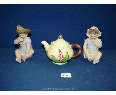 A Carltonware Foxglove teapot and two bisque piano babies.