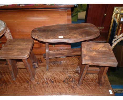 A small wooden table in the form of a tree trunk and two small stools, possibly a child's set, table 25'' w x 17'' h x 11 1/2