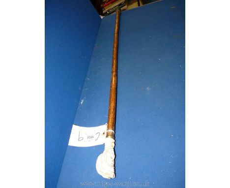 A walking Stick with composite knop in the form of a jockey's head.