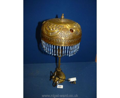 A brass table lamp with blue beaded droplets and a gemstone decorated shade, 18" tall.