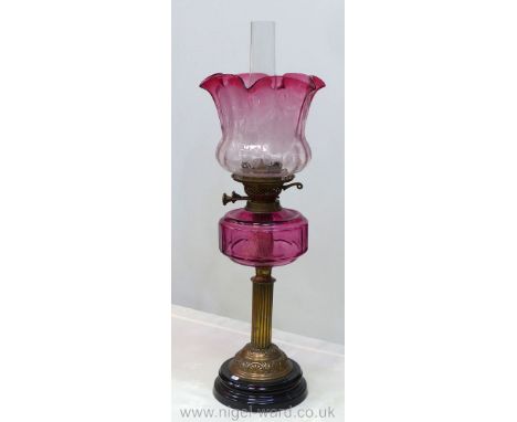 A fine old brass column Victorian Oil Lamp on heavy brass ceramic base, clear glass cranberry font with tulip shaped fluted s