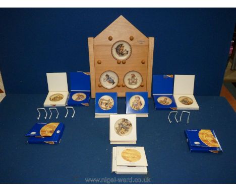 A Hummel display shelf together with ten Hummel plates to include 'Umbrella Boy', 'Just Resting', 'Umbrella Girl', 'Wayside H