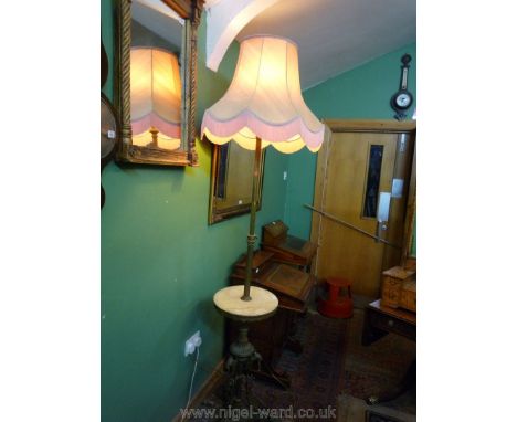 An unusual and heavy Brass pillar standard Lamp, adjustable for height and having a circular marble shelf, the base with orna