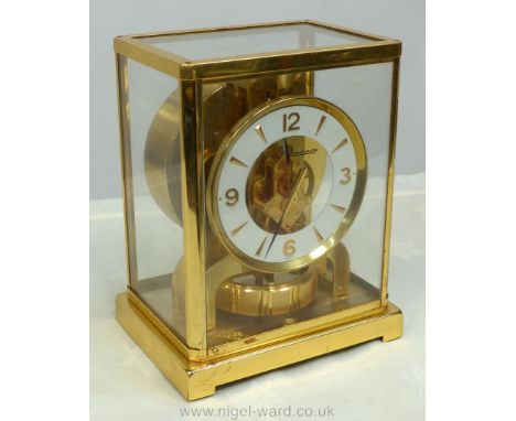 A ''Jaeger-Le Coultre Atmos" Brass and glass cased Bracket/Mantel clock, the 4 3/4'' diameter face having Arabic numerals at 