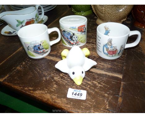 A Wedgwood 'Thomas the Tank Engine' cup and money box, 'Peter Rabbit' cup (chip to rim) and a china duck.