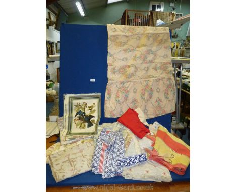 A box of mixed fabric including green table coverings, nature print fabric, curtains, bed throws etc.