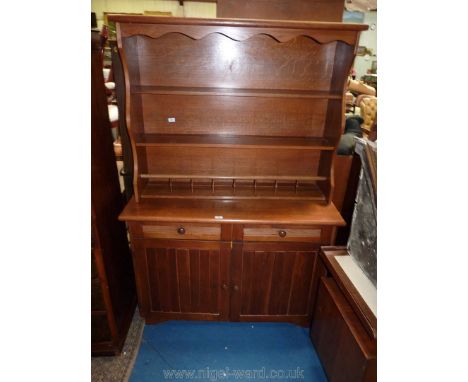 A contemporary Oak Kitchen Dresser having a pair of opposing doors and pair of frieze drawers to the base and complete with r
