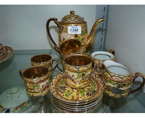 An Oriental coffee set having gold colour interior with heavy embossing pattern:  coffee pot, five coffee cups, six saucers, 