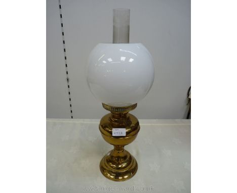 A brass Oil Lamp with twin burner and chimney and a white milk glass globular shade, 16 1/2'' to top of shade