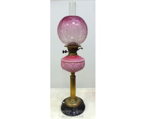 An fine old brass Oil Lamp with Corninthian column, pretty pink shell embossed reservoir and pink etched globe shade, 25 1/2'