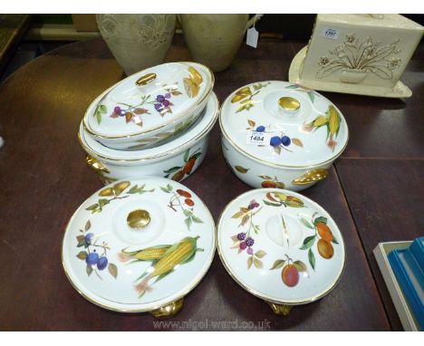 A large lidded tureen in Evesham pattern by Royal Worcester, two smaller serving dishes, a large oval serving dish and lid an