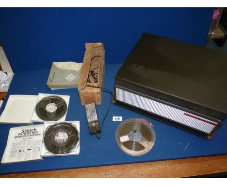 A 1960's Telefunken reel to reel tape recorder with microphone and tapes.