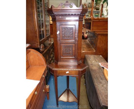 An unusual and compact lightwood strung dark Oak Corner Cupboard on stand having two carved panels to the door with the initi