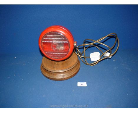 A Massey Ferguson Headlight with tractor logo on lens converted to a table lamp.