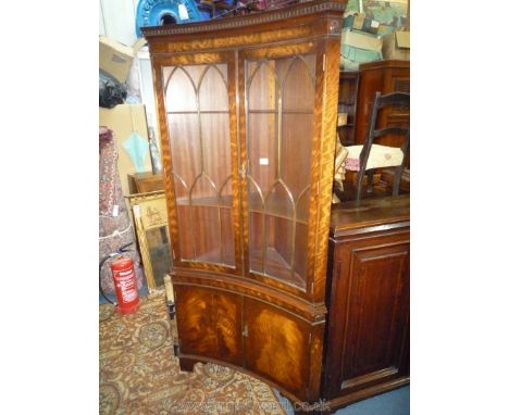 An attractive reverse bow front Mahogany Display Cabinet on Cupboard having a pair of eight pane doors, the base with a pair 