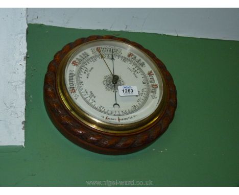 An aneroid Barometer with brass dial.
