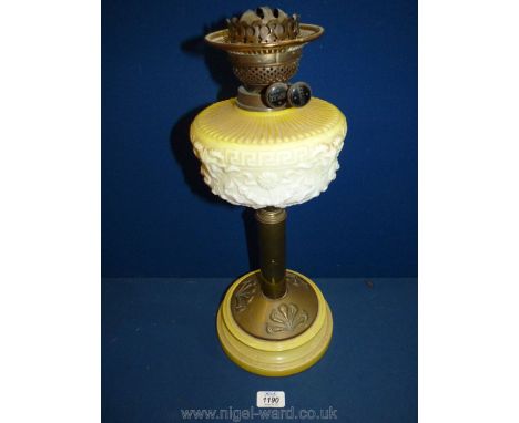 A Brass oil Lamp with yellow and white glass reservoir, twin wicks and brass pillar, standing on china base, 18'' tall.