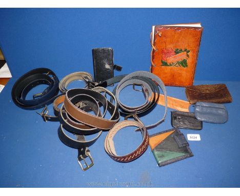 A quantity of leather belts, purses, key holder, comb holder and mobile phone carrier, etc.