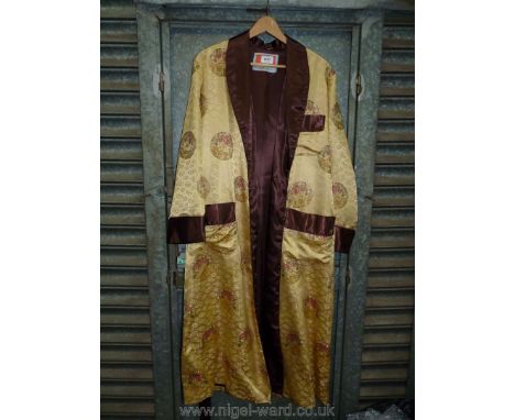Am oriental Dressing Gown in brown and gold with circular panels of embroidered dragons, slim shawl collar and patch pockets,