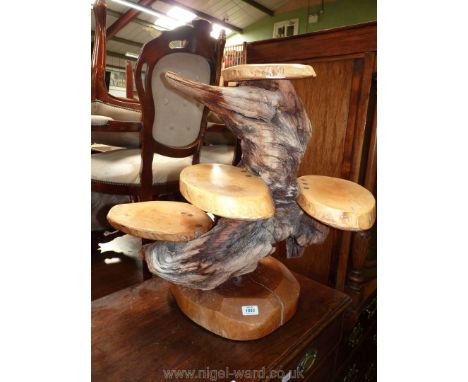A gnarled wood and tree trunk slice Etagere/plant stand with four platforms, 25 1/2'' maximum width x 25'' high approx.