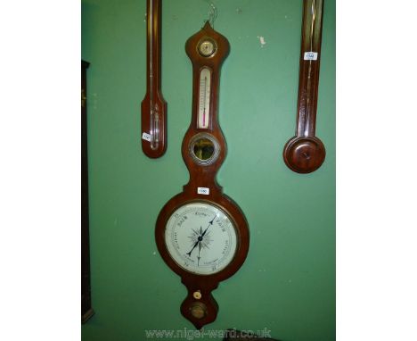 A large Mahogany wheel Barometer and thermometer with damp/dry indicator and mirror, 40" long