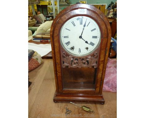 A large Victorian Walnut cased mantle Clock with Roman numerals, 24'' tall with key.