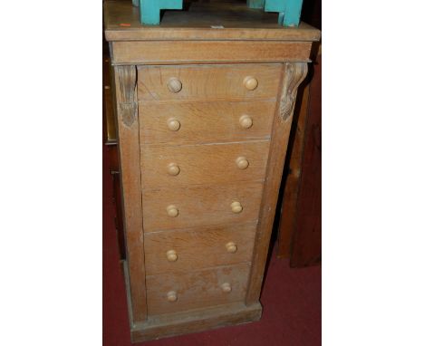 A Victorian light oak six drawer Wellington chest, having lockable hinged upright (handles are replacement, and backboards re