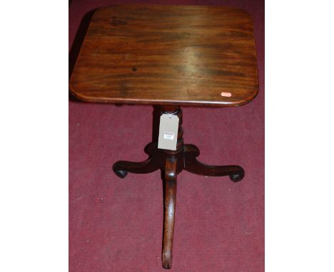 An early 19th century mahogany round cornered tilt top pedestal tripod table