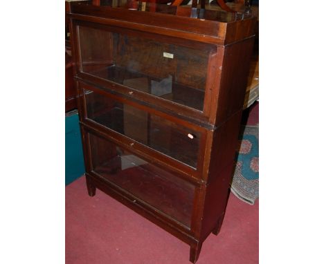 A 1930s mahogany three-tier Globe Wernicke stacking bookcase, having typical hinged glazed doors, w.87cm