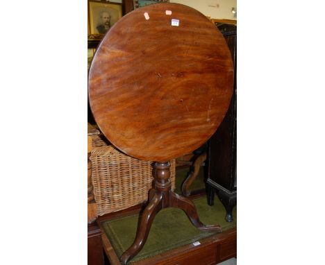 An early 19th century mahogany circular tilt top pedestal tripod table, dia. 67.5cm