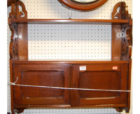 An Edwardian walnut double door hanging wall shelf, width 61cm