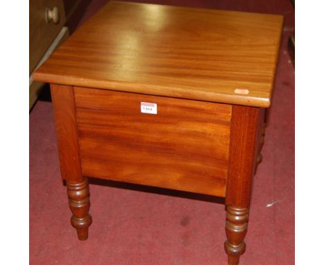 A Victorian mahogany hinge top commode having a fitted interior on turned supports, width 45cm