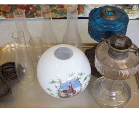 Iron base and blue bowl oil lamp, a cut glass oil lamp and various chimneys 