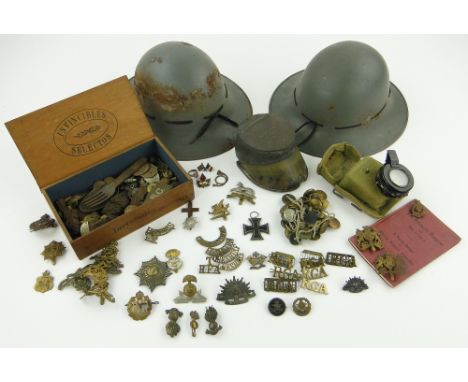 A collection of militaria
comprising Regimental cap badges, 1924 horse hoof inkwell, Second World War prismatic compass, regi