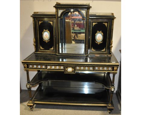 A 19th century French ebonised bureau plat,
having a fitted cabinet to the top, the doors having inset porcelain panels, the 
