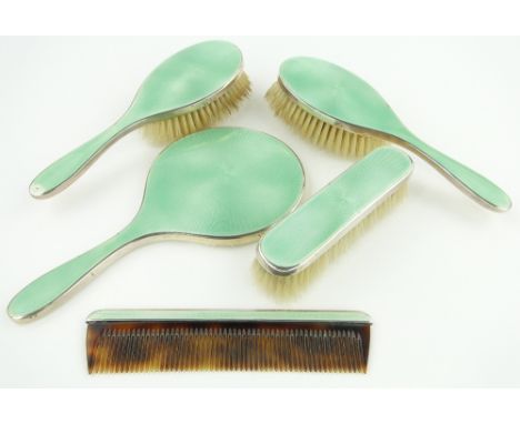 A 5-piece silver and pale green enamel backed brush and mirror set,
London 1956.