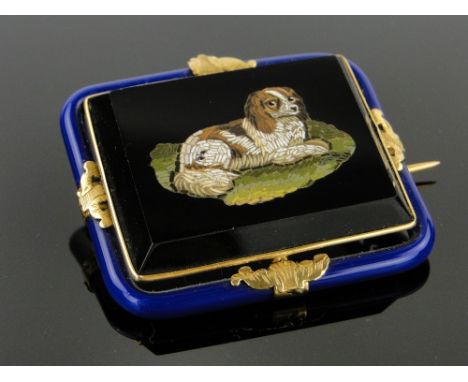 A Victorian micro mosaic brooch,
depicting a King Charles spaniel, in unmarked gold and blue enamel frame, width 43mm.