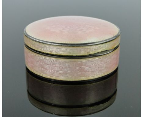 A circular silver and pink enamel box,
with hinged lid, import marks Birmingham 1942, 6cm across.