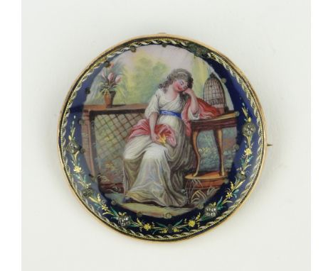 An 18/19th century French enamel circular brooch,
with painted study of a lady beside a bird cage, unmarked gold frame, 55mm 