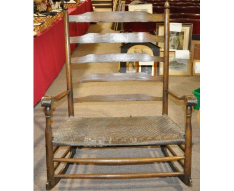 An early 19th century (Amish) country oak ladder back rocking chair,
width 3'.