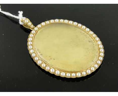 An 18ct gold photo pendant,
with pearl set surround and pearl mounted bale, height excluding bale 52mm.