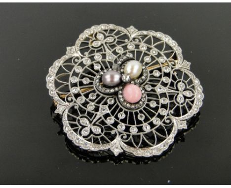 A fine quality 18ct white gold pierced fretwork pendant/brooch circa 1920,
set with a central cluster of 3 coloured pearls in