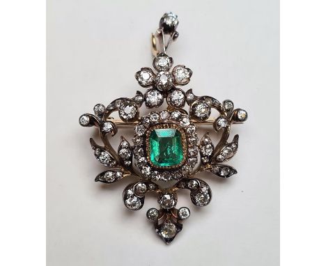 Late 19th/early 20th century gold-coloured and white metal emerald and diamond pendant/brooch, the central emerald-cut emeral