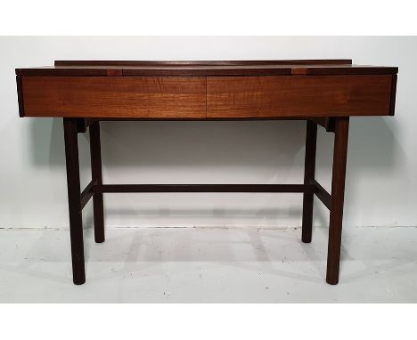 Mid century teak dressing table, the rectangular top above two drawers, handles inset into the cut-outs of the top, on circul