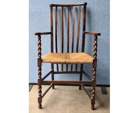 Stickback chair with rush seat, barley twist and block supports, stretchered base Condition ReportThe left arm is very slight