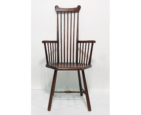 Circa 1920's stickback armchair, possibly J S Henry of London with carved top rail, stick back and the hexagonal dished seat,